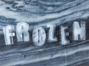 Frozen ice cubes in the shape of the word "frozen"