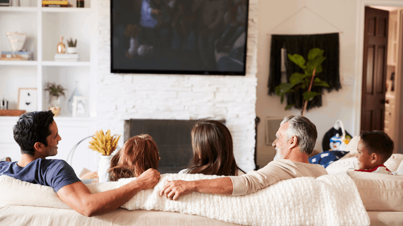 Family sitting on couch enjoying HVAC scenting aromas