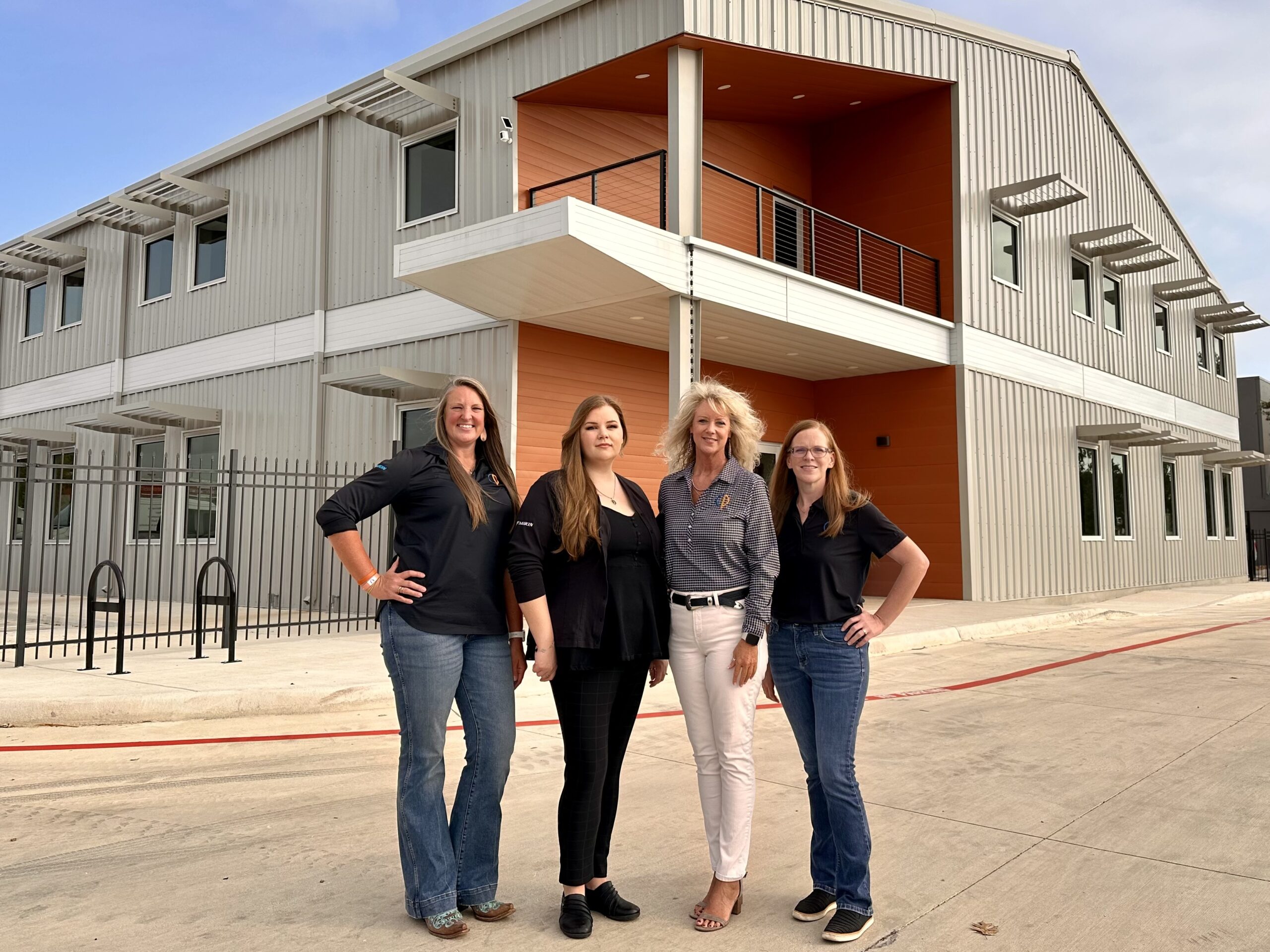4 Comfort Air employees smiling at the camera